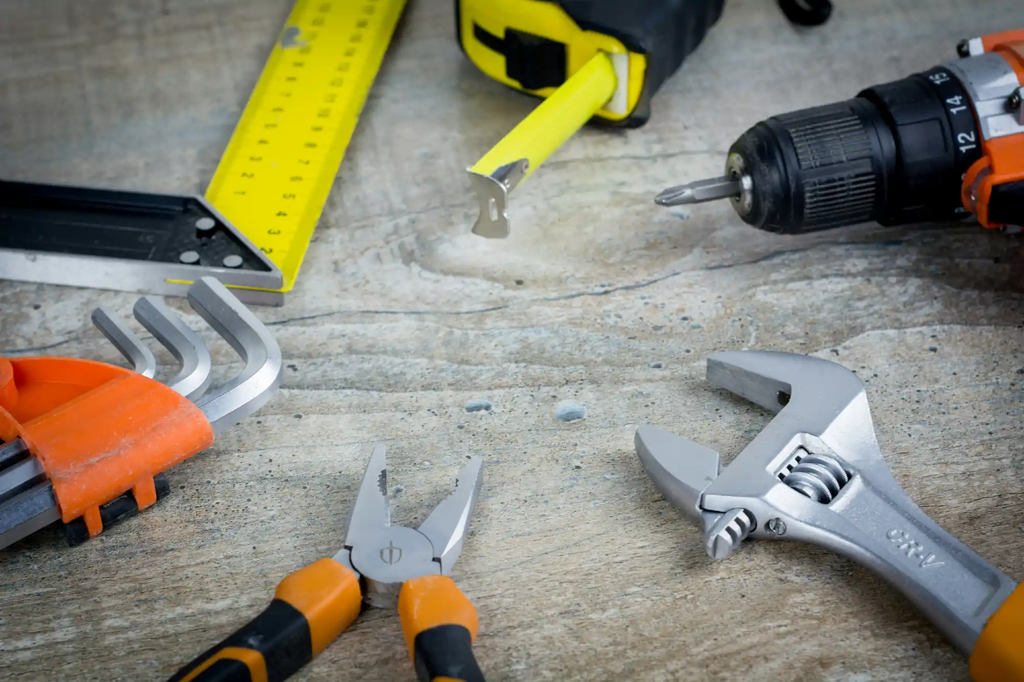 Home repair tools arranged on a workshop table